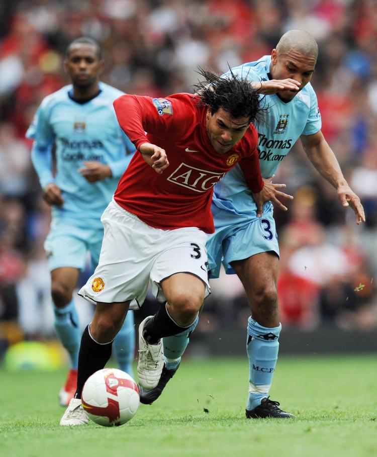 CHANCE TO SHINE: Carlos Tevez (front) fends off a Manchester City defender in another strong performance for United. (PAUL ELLIS/AFP/Getty Images) CHANCE TO SHINE: Carlos Tevez (front) fends off a Manchester City defender in another strong performance for United. (PAUL ELLIS/AFP/Getty Images)