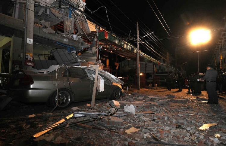 Thai policemen inspect the site of a bomb blast in Nonthaburi on October 5, 2010. (STR/AFP/Getty Images) Thai policemen inspect the site of a bomb blast in Nonthaburi on October 5, 2010. (STR/AFP/Getty Images)
