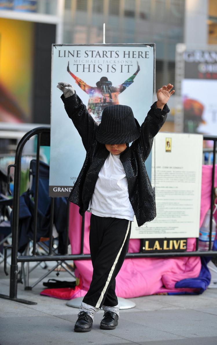 Five-year-old Victor Chupina shows his moves after sleeping outside for a second night to buy tickets to a special pre-screening of the Michael Jackson film 'This Is It,' at LA Live in Los Angeles on September 26. (Robyn Beck/AFP/Getty Images)