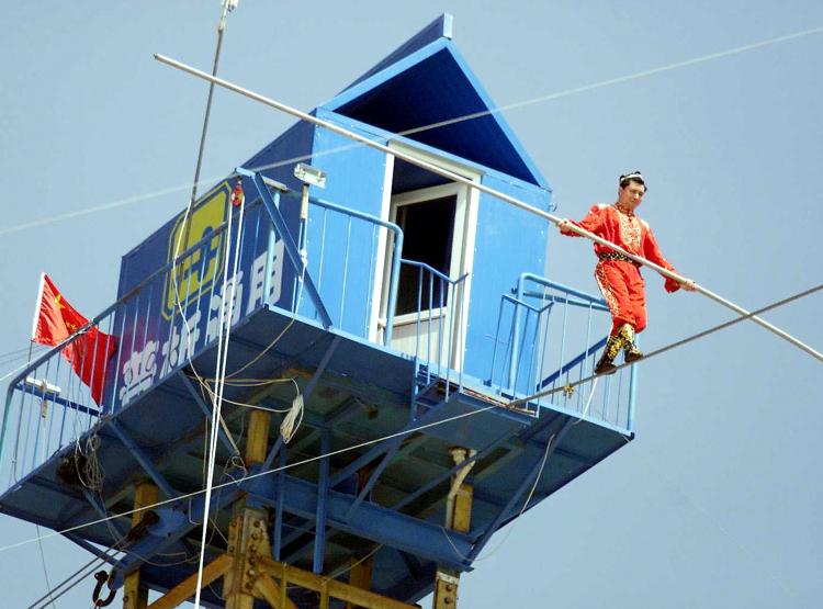 Chinese tightrope walker Adili Wushouer, a Uighur from China's western Xinjiang Province. Wushouer broke the world record for tightrope walking in the air on July 5 in Kanas, Xinjiang. (AFP/Getty Images) Chinese tightrope walker Adili Wushouer, a Uighur from China's western Xinjiang Province. Wushouer broke the world record for tightrope walking in the air on July 5 in Kanas, Xinjiang. (AFP/Getty Images)