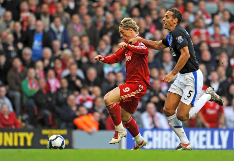 Liverpool&lsquo;s Fernando Torres (left) pulls away from Manchester United&lsquo;s Rio Ferdinand to score the game&lsquo;s opening goal. (Paul Ellis/AFP/Getty Images)