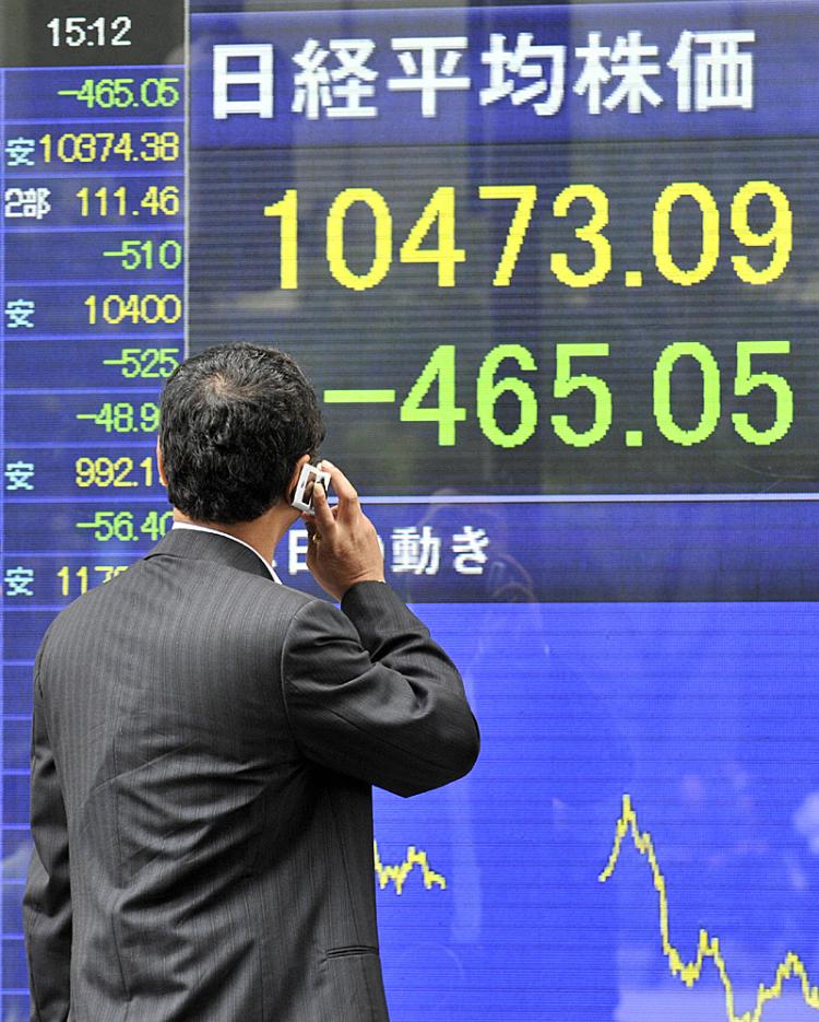 A businessman gazes at a share prices board in Tokyo showing share prices plummeting. (Yoshikazu Tsuno/AFP/Getty Images) A businessman gazes at a share prices board in Tokyo showing share prices plummeting. (Yoshikazu Tsuno/AFP/Getty Images)