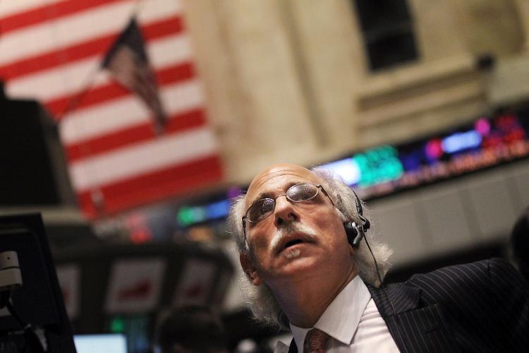 STOCKS SOAR: A trader works on the floor of the New York Stock Exchange (NYSE) in New York City. U.S. stocks rallied on Monday, sending the Dow Jones Industrial Average up 208 points on the first day of trading in August.  (Mario Tama/Getty Images)