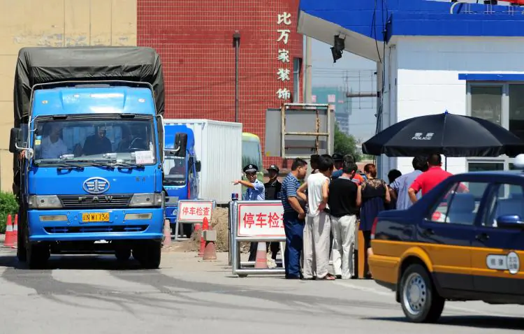 Truckers get their registration checked. In some areas in China, drivers are forced to pay fines that sometimes bought exemption from a traffic law violation for several months. (Frederic J. Brown/AFP/Getty Images)