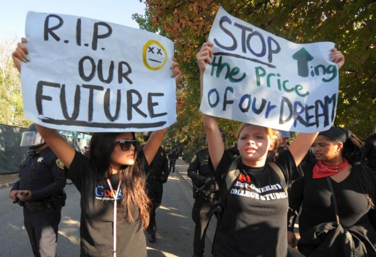 Student protesters hold banners outside a police line during a protest against an increase in student fees at the UCLA campus in Los Angeles on Nov. 19.  (Mark Ralston/AFP/Getty Images)