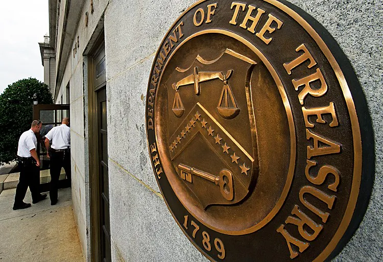U.S. Secret Service Uniform Division officers walk in the door near the seal on the U.S. Treasury building in Washington, on Aug. 9, 2011. (Paul J. Richards/AFP/Getty Images)