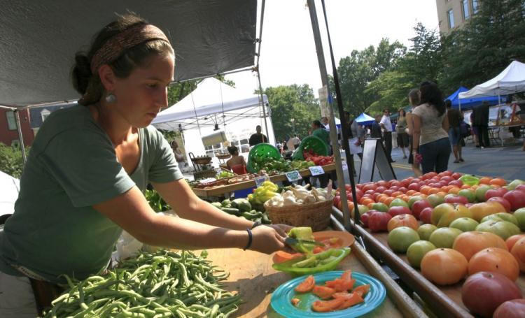 A vendor cuts heirloom tomatoes to serve as samples for potential customers at a farmer's market in Washington, D.C. Small farmers selling direct to consumers, restaurants, and hotels are exempt from new regulations recently passed in the Food Safety Mode (Abdullah Pope/AFP/Getty Images) A vendor cuts heirloom tomatoes to serve as samples for potential customers at a farmer's market in Washington, D.C. Small farmers selling direct to consumers, restaurants, and hotels are exempt from new regulations recently passed in the Food Safety Mode (Abdullah Pope/AFP/Getty Images)