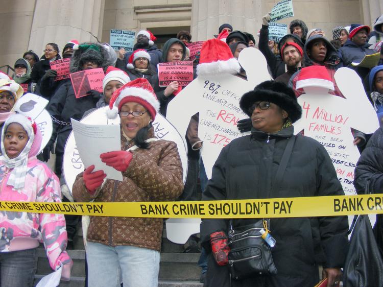 Protesters rallied on Wall Street against an estimated $143 billion worth of bonus packages to bank executives. Desiree Pilgram-Hunter (R, in black coat), whose family has been greatly impacted by the financial crisis, was among the protesters. (Gidon Belmaker/ The Epoch Times) Protesters rallied on Wall Street against an estimated $143 billion worth of bonus packages to bank executives. Desiree Pilgram-Hunter (R, in black coat), whose family has been greatly impacted by the financial crisis, was among the protesters. (Gidon Belmaker/ The Epoch Times)