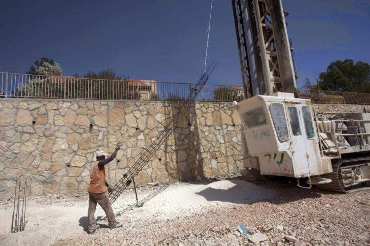 A worker prepares foundation for a new house on September 27, 2010 in the West Bank settlement of Kokhav Hashahar as Israel ended its 10-month settlement freeze in the West Bank. (Menahem Kahana/AFP/Getty Images) A worker prepares foundation for a new house on September 27, 2010 in the West Bank settlement of Kokhav Hashahar as Israel ended its 10-month settlement freeze in the West Bank. (Menahem Kahana/AFP/Getty Images)