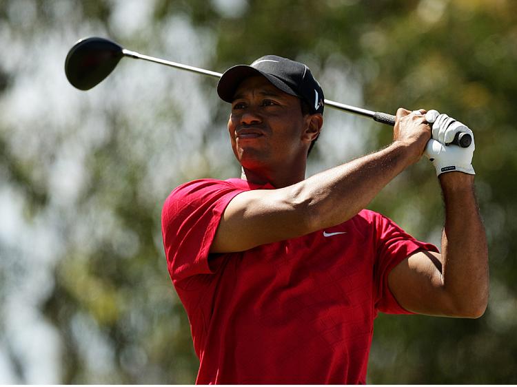 THE GOOD OLD DAYS: Tiger Woods last month before the news of his multiple mistresses surfaced. Here, Woods tees off at the 2009 Australian Masters, Nov. 15 in Melbourne, Australia. (Mark Dadswell/Getty Images)