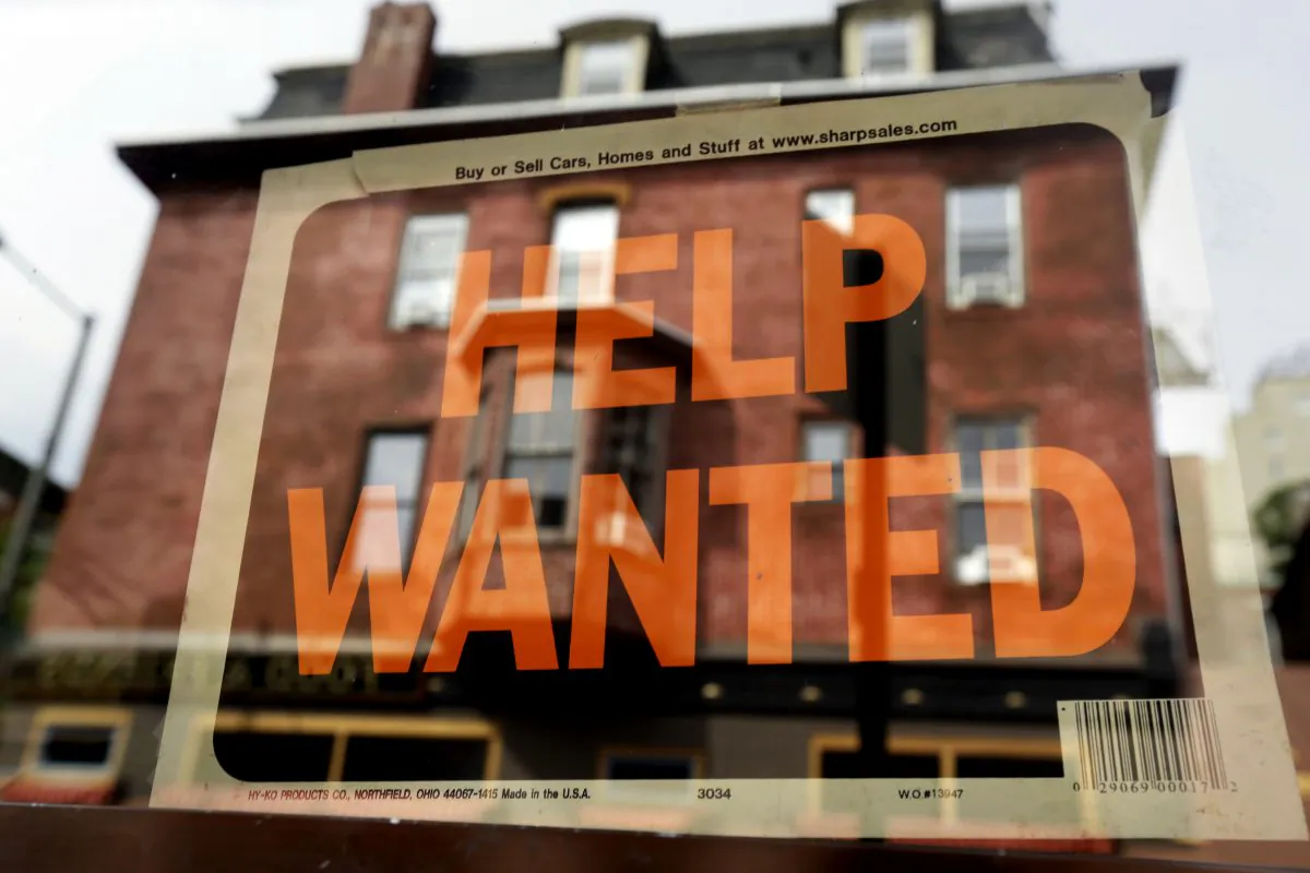 In this Aug. 19, 2013 file photo, a Philadelphia business displays a help wanted sign in its storefront. (AP Photo/Matt Rourke)