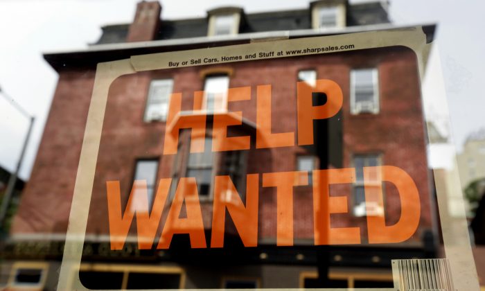 In this Aug. 19, 2013 file photo, a Philadelphia business displays a help wanted sign in its storefront. (AP Photo/Matt Rourke)