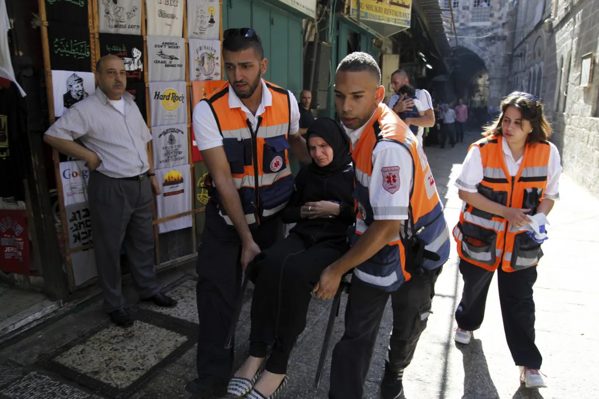 Paramedics carry an injured Palestinian woman during confrontations in the Old City of Jerusalem, Monday, Sept. 28, 2015. (AP Photo/Mahmoud Illean)