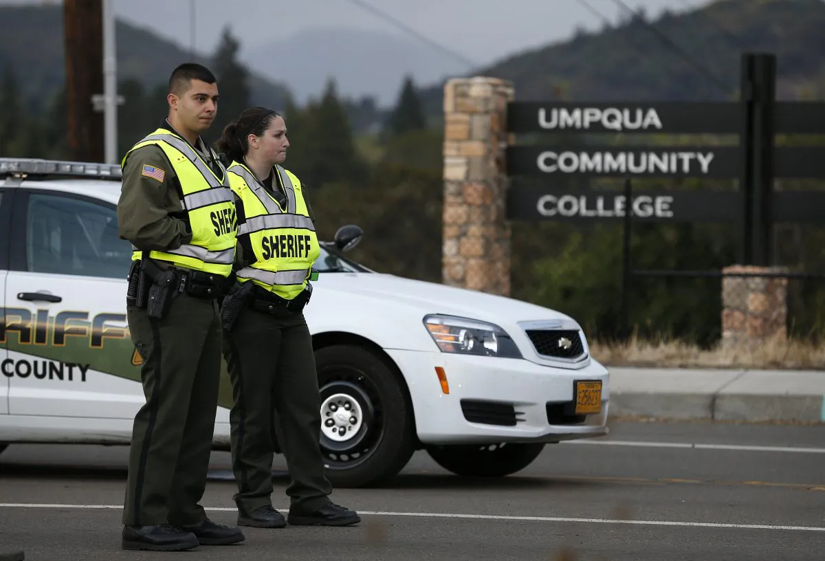 Sheriff's deputies man a roadblock on the road leading to Umpqua Community College Saturday, Oct. 3, 2015, in Roseburg, Ore. (AP Photo/John Locher)