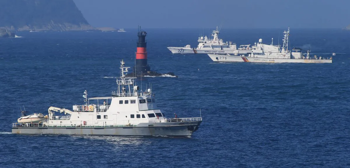 South Korean Coast Guard ships sail to search for missing passengers who were on a capsized fishing boat in the water off north of the resort island of Jeju, South Korea, Sunday, Sept. 6, 2015. (Park Ji-ho/Yonhap via AP)
