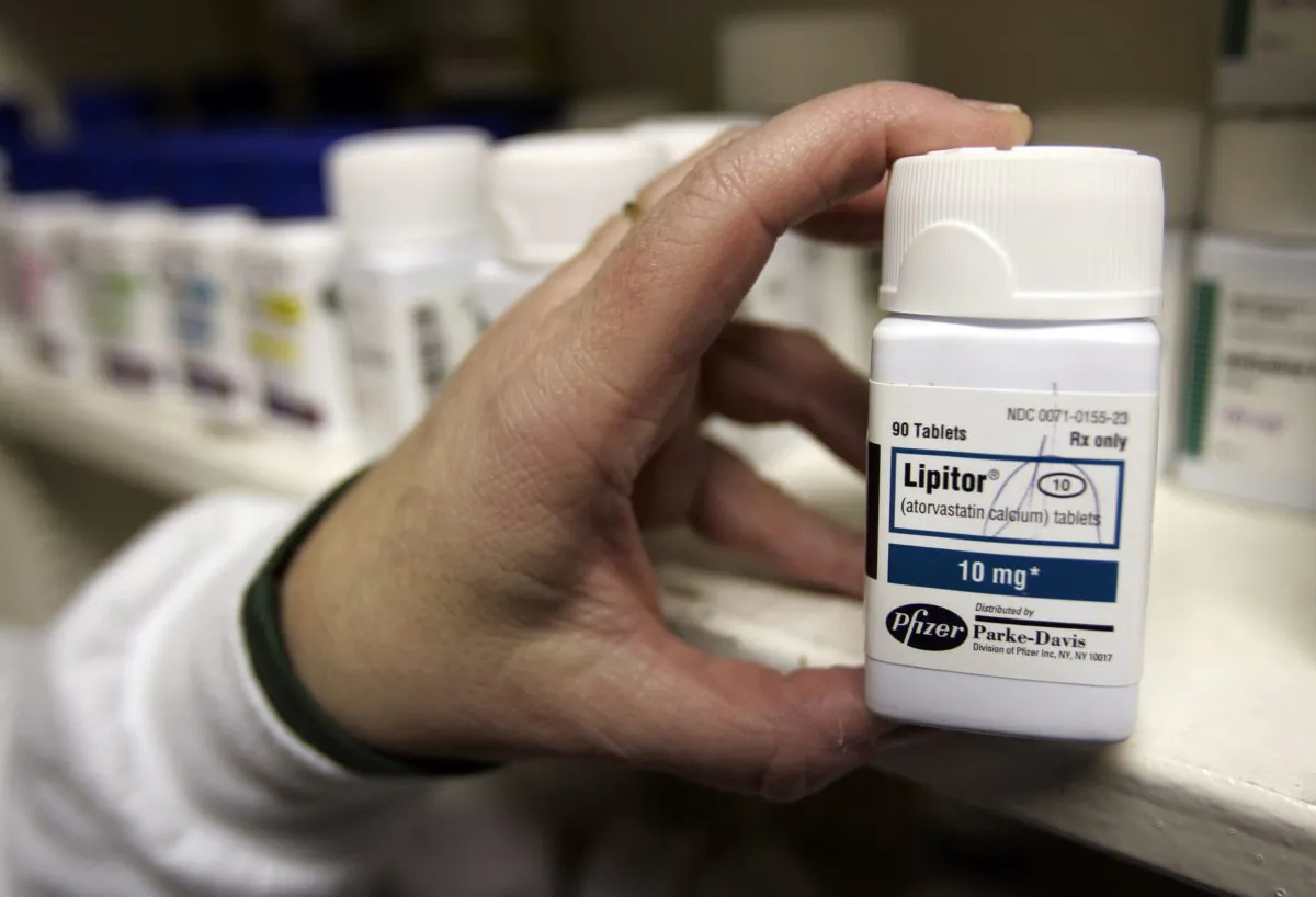A pharmacist holds a bottle of the prescription drug Lipitor at a Maximart pharmacy in Palo Alto, Calif., on Dec. 14, 2007. (Paul Sakuma/AP)