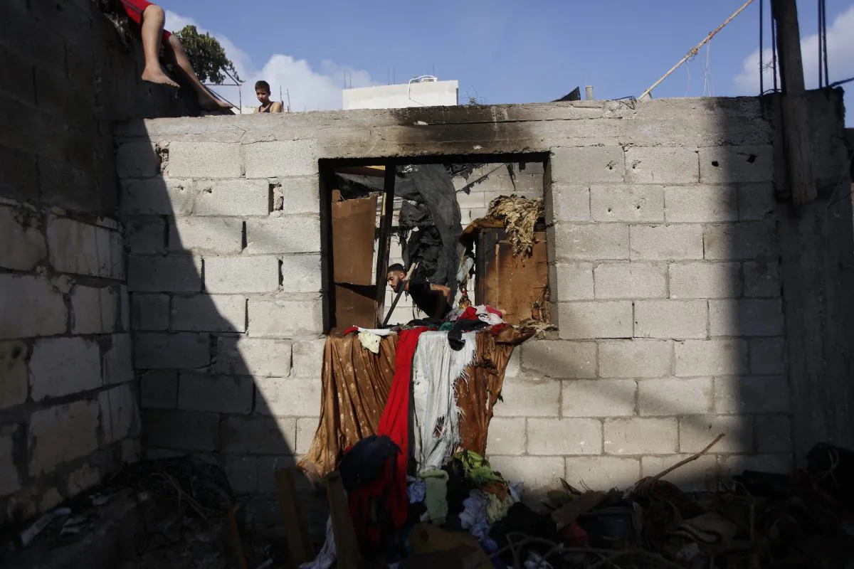 Palestinians inspect the house of Qais al-Saadi, a member of the Hamas' al-Qassam Brigades, after an Israeli military raid in the West Bank city of Jenin, Sunday, Oct. 4, 2015. (AP Photo/Majdi Mohammed)