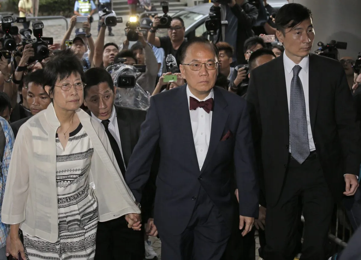 Donald Tsang (C) former leader of Hong Kong and his wife Selina arrive at a magistrates' court in Hong Kong on Oct. 5, 2015. (AP Photo/Vincent Yu)
