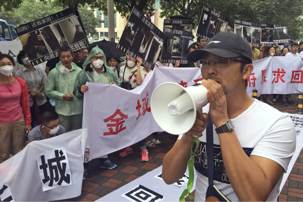 Residents demanding compensation for damages to their homes after a massive explosion in Tianjin on Wednesday, Aug. 19, 2015. (AP Photo/Paul Traynor)