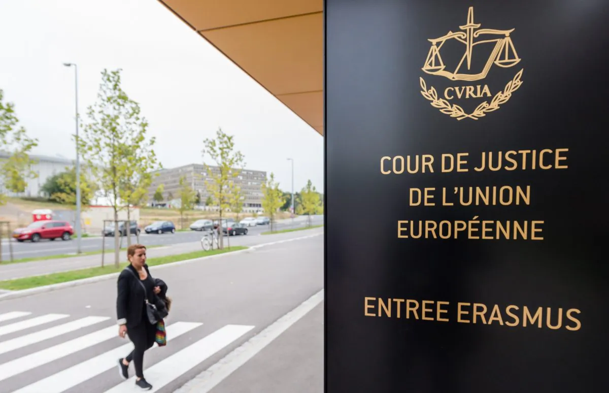 In this photo taken on Monday, Oct. 5, 2015 a woman walks by the entrance to the European Court of Justice in Luxembourg. Europe's highest court has ruled in favor of an Austrian law student who claims a trans-Atlantic data protection agreement doesn't adequately protect consumers. (Geert Vanden Wijngaert)