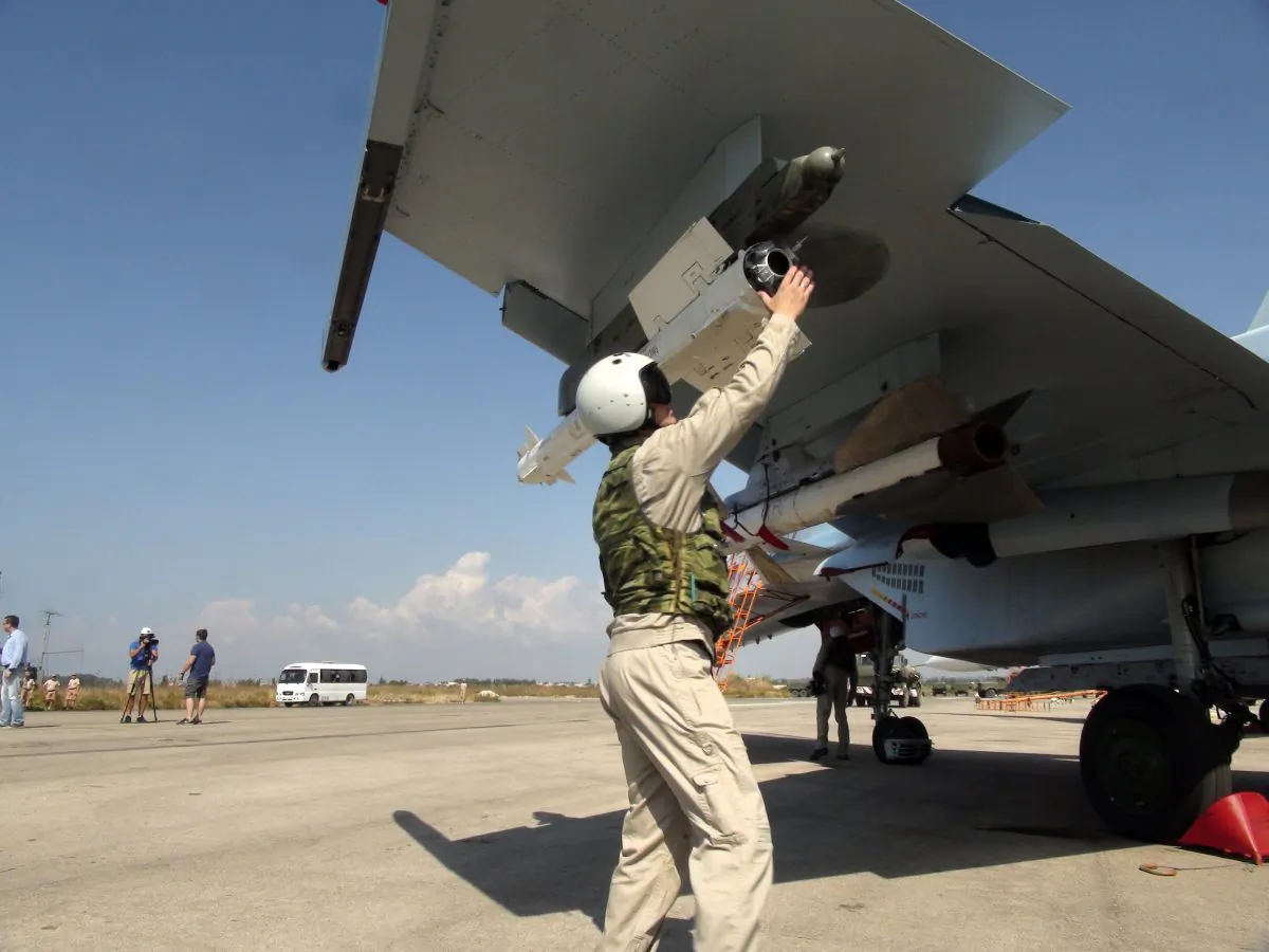 Russian pilot fixes an air-to-air missile at his Su-30 jet fighter before a take off at Hmeimim airbase in Syria, on Monday, Oct. 5, 2015. (AP Photo/Dmitry Steshin, Komsomolskaya Pravda, Photo via AP)