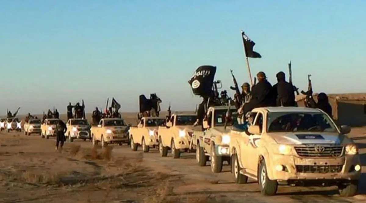 ISIS group ride in a convoy, which includes multiple Toyota pickup trucks, through Raqqa city in Syria, in a file photo. (Militant website via AP, File)