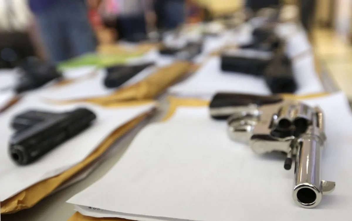 Chicago police display some of the thousands of illegal firearms they have confiscated so far this year in their battle against gun violence in Chicago on July 7, 2014. (AP Photo/M. Spencer Green)