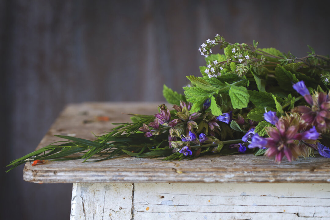 Assortment of fresh herbs mint, oregano, thym, blooming sage (NatashaBreen/iStock)