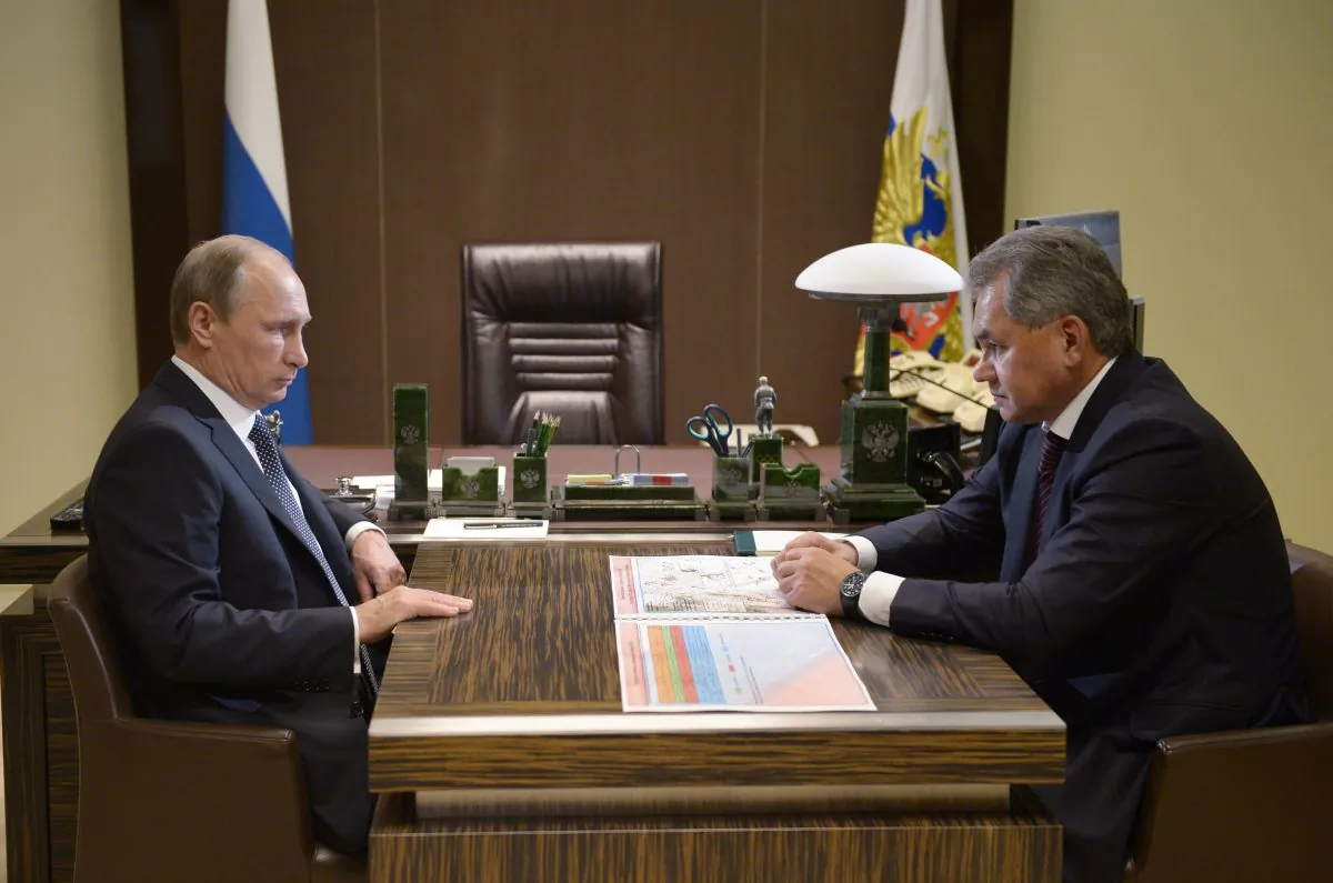 Russian President Vladimir Putin (L) listens to Defense Minister Sergei Shoigu at a meeting in the Bocharov Ruchei residence, Sochi, Russia, on Oct. 7, 2015. (Alexei Nikolsky/RIA-Novosti via AP)