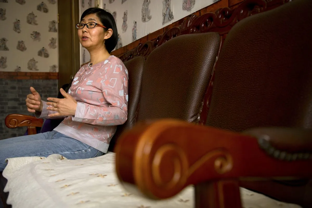 Chinese lawyer Wang Yu speaks during an interview in Beijing. China's state media on July 14, 2015. (AP Photo/Mark Schiefelbein)