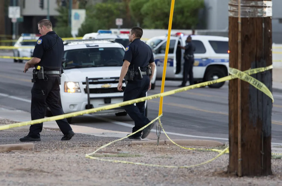 Phoenix police officers arrive at the scene where a Phoenix police officer was shot early Wednesday, Sept. 16, 2015 in Phoenix, Ariz. (Emmanuel Lozano/The Arizona Republic via AP)