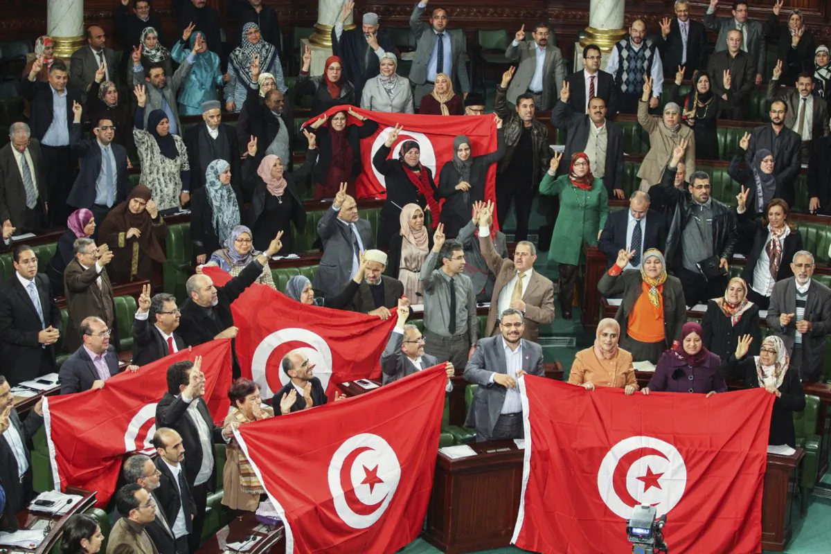 Tunisian National Constituent Assembly celebrate the adoption of the new constitution in Tunis, Tunisia, on Jan. 26, 2014. (AP Photo/Aimen Zine, File)
