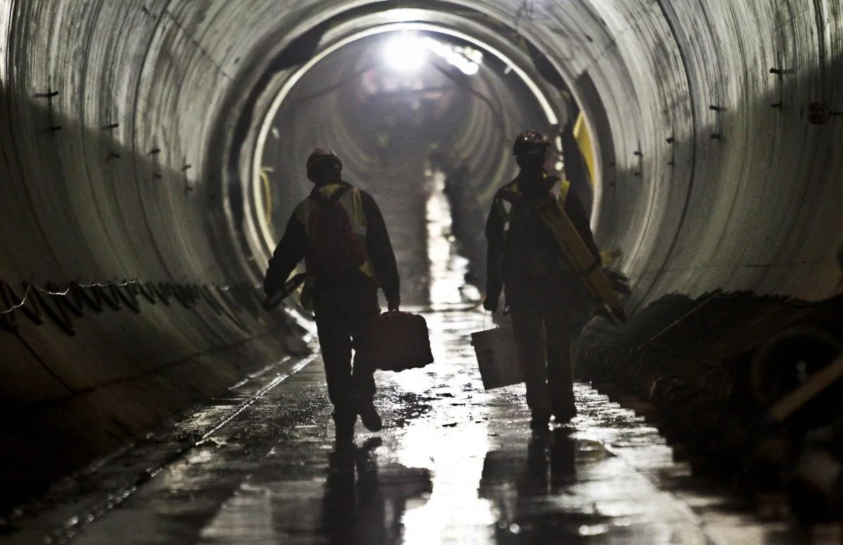In this May 2, 2014, file photo, construction workers walk between the 72nd Street and 86th Street section of the Second Avenue subway tunnel in New York. (AP Photo/Bebeto Matthews)