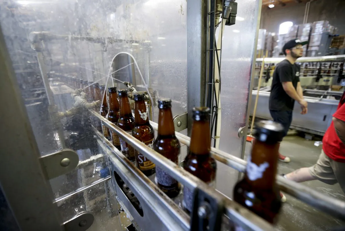Bottles of beer are cleaned using recycled non-potable water during the bottling process at Stone Brewing Co. (AP Photo/Gregory Bull)