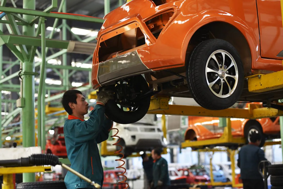Workers assemble automobiles in a factory in Zouping, east China's Shandong province on Dec. 16, 2014. (STR/AFP/Getty Images)