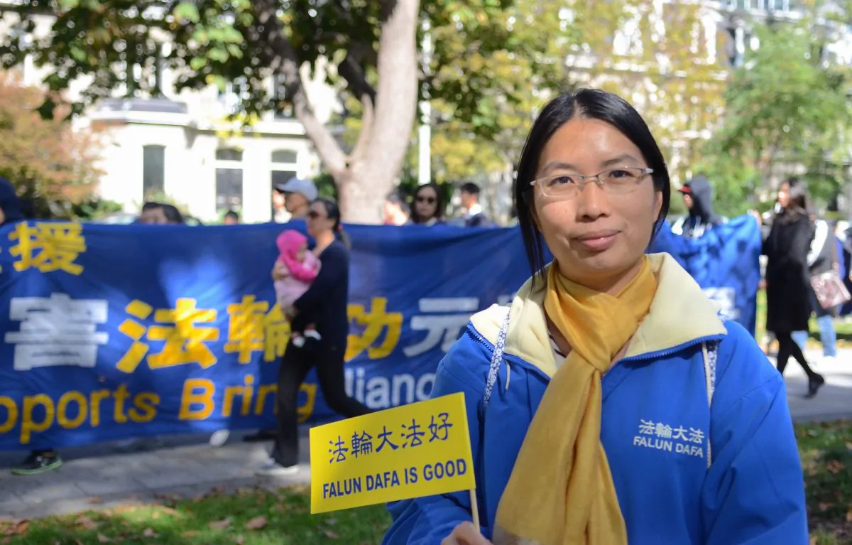 Dong Zhen shares her tale of imprisonment and torture in China for her practice of Falun Gong. She took part in a march through the streets of Toronto in support of others who have faced similar fates in China. (Matthew Little/Epoch Times)