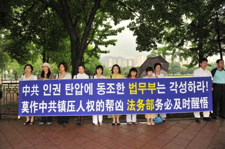 Falun Gong practitioners in South Korea are displaying a banner at a press conference in front of the Korean government building complex in Gwacheon on Jan. 24, 2011, protesting South Korea's decision to deport Falun Gong practitioners back to China. (Jin Guohuan/The Epoch Times) Falun Gong practitioners in South Korea are displaying a banner at a press conference in front of the Korean government building complex in Gwacheon on Jan. 24, 2011, protesting South Korea's decision to deport Falun Gong practitioners back to China. (Jin Guohuan/The Epoch Times)