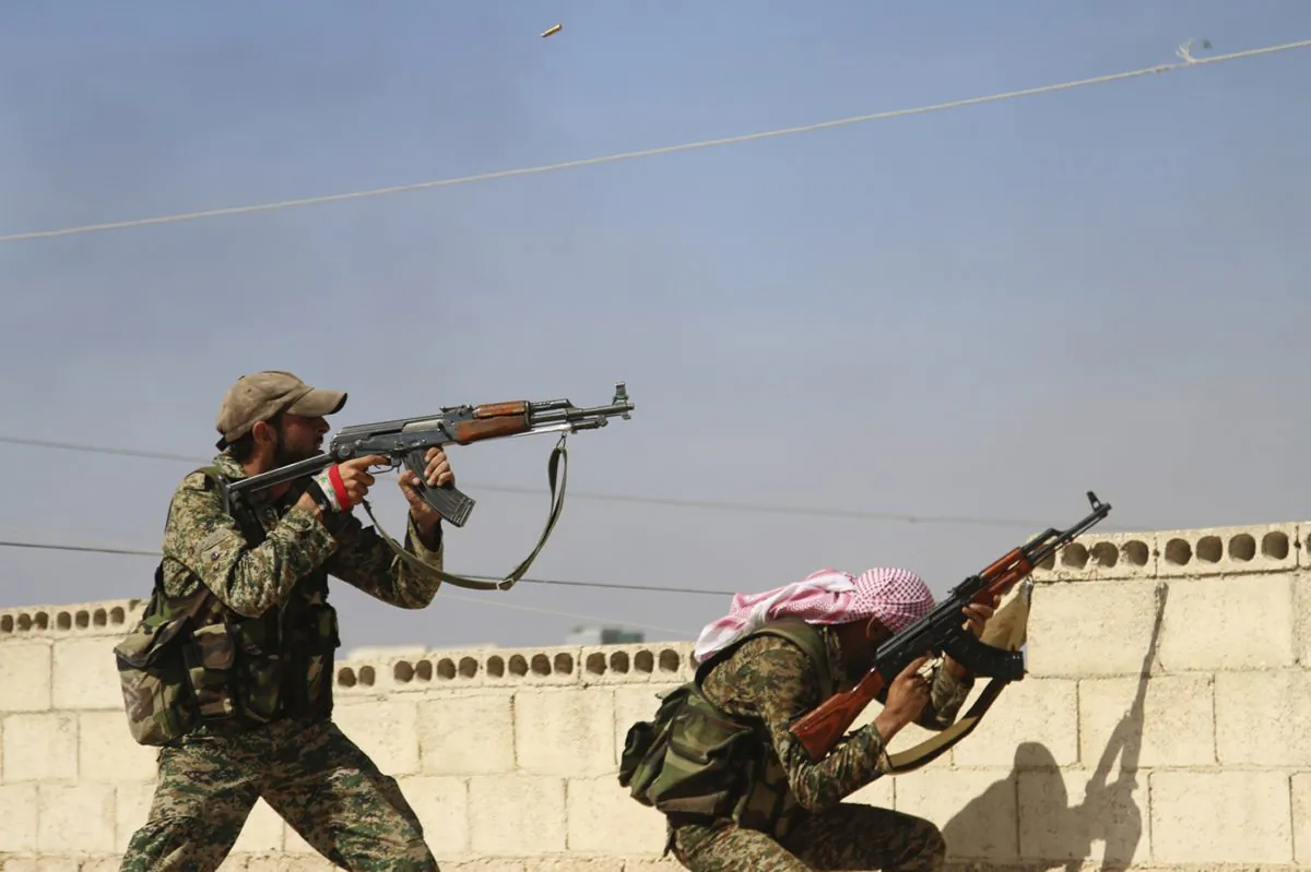 In this photo taken on Sunday, Oct. 11, 2015, Syrian soldiers fire repelling an attack in Achan, Hama province, Syria. (Alexander Kots/Komsomolskaya Pravda via AP)