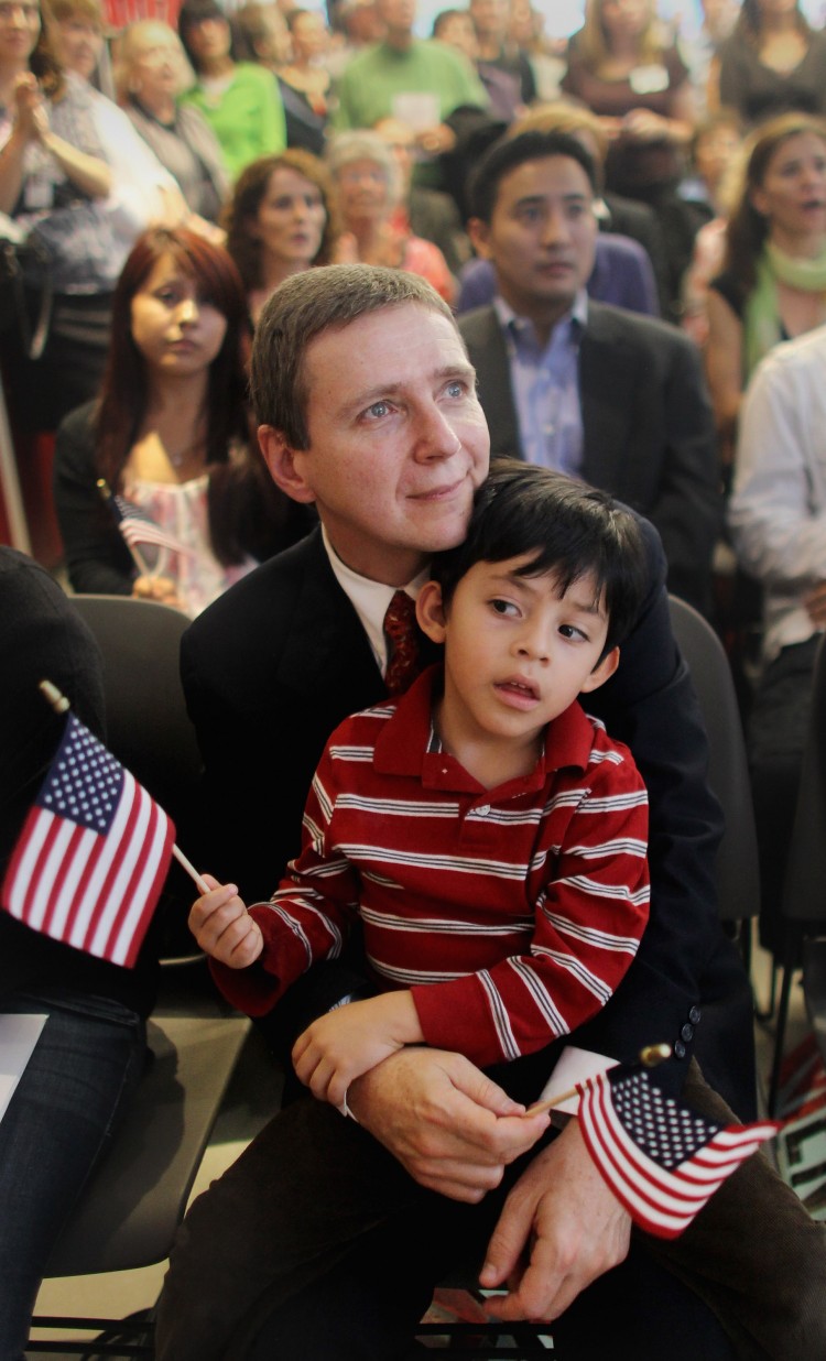 New citizen Istvan Becze holds his son Samuel, 4, during a naturalization ceremony for 18 immigrants from 16 countries at the Lower East Side Tenement Museum on Sept. 20. (Mario Tama/Getty Images) New citizen Istvan Becze holds his son Samuel, 4, during a naturalization ceremony for 18 immigrants from 16 countries at the Lower East Side Tenement Museum on Sept. 20. (Mario Tama/Getty Images)