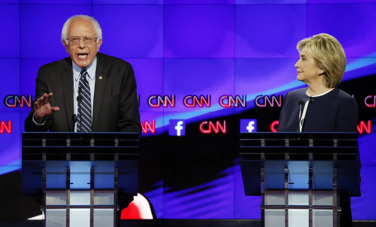 Hillary Rodham Clinton, right, listens as Sen. Bernie Sanders, of Vermont, speaks during the CNN Democratic presidential debate Tuesday, Oct. 13, 2015, in Las Vegas. (AP Photo/John Locher)