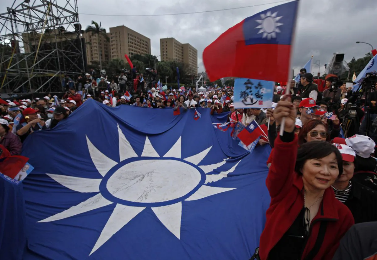 A supporter of Taiwan's President and presidential candidate Ma Ying-jeou waves a national flag during an election campaign rally Sunday, Jan. 8, 2012 in Taipei, Taiwan. Taiwan will hold its presidential election on Jan. 14. (AP Photo/Vincent Yu)