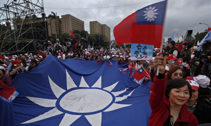 A supporter of Taiwan's President and presidential candidate Ma Ying-jeou waves a national flag during an election campaign rally Sunday, Jan. 8, 2012 in Taipei, Taiwan. Taiwan will hold its presidential election on Jan. 14. (AP Photo/Vincent Yu)