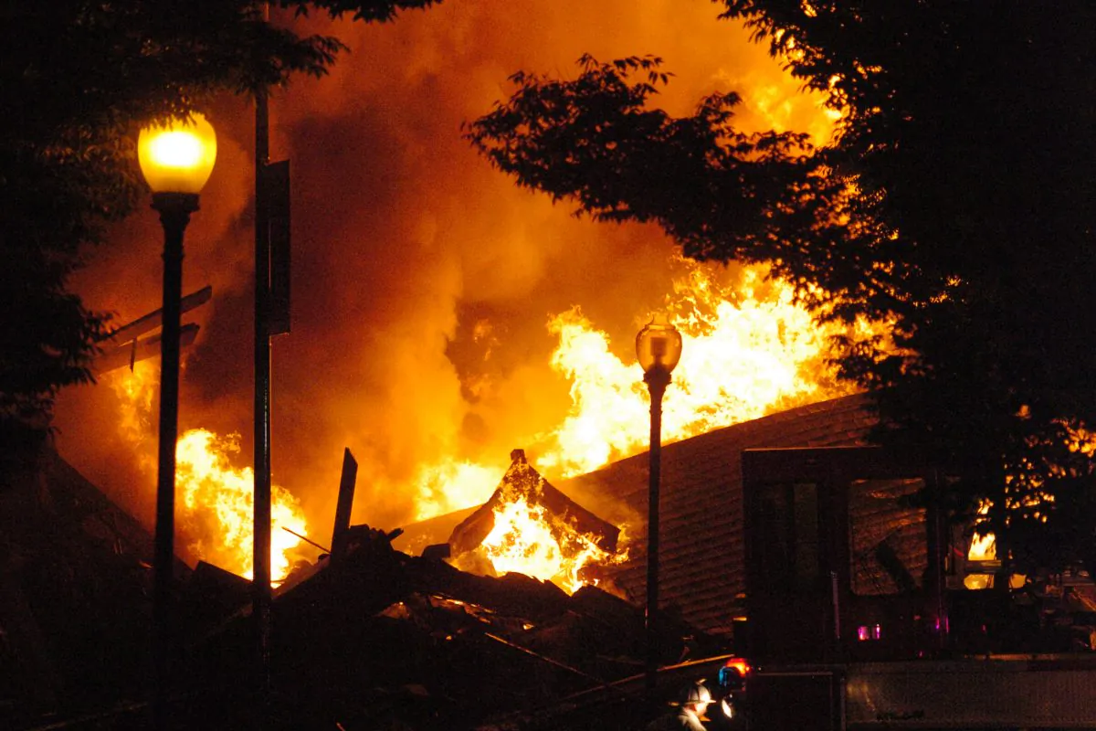 A fully-engulfed fire burns on Independence Avenue near Prospect in Kansas City, Mo., Monday, Oct. 12, 2015. (T. Rob Brown/The Kansas City Star via AP)