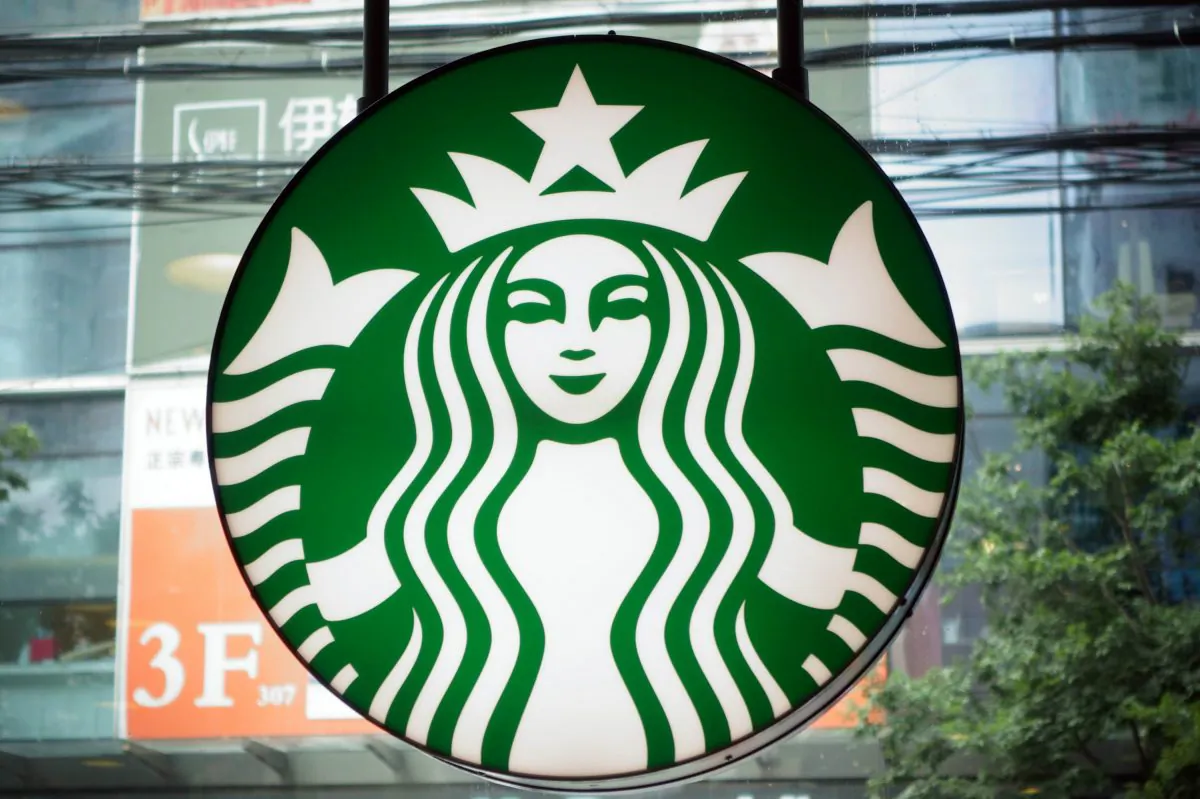 A Starbucks logo is pictured next to a McDnald's restaurant on July 28, 2014 in Shanghai. (Johannes Elsele/AFP/Getty Images)