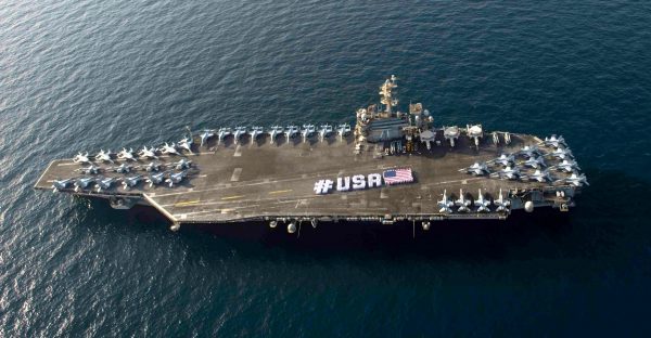 Sailors spell out #USA with the American flag on the flight deck of the aircraft carrier USS Theodore Roosevelt. (Mass Communication Specialist 3rd Class/U.S. Navy, CC BY)