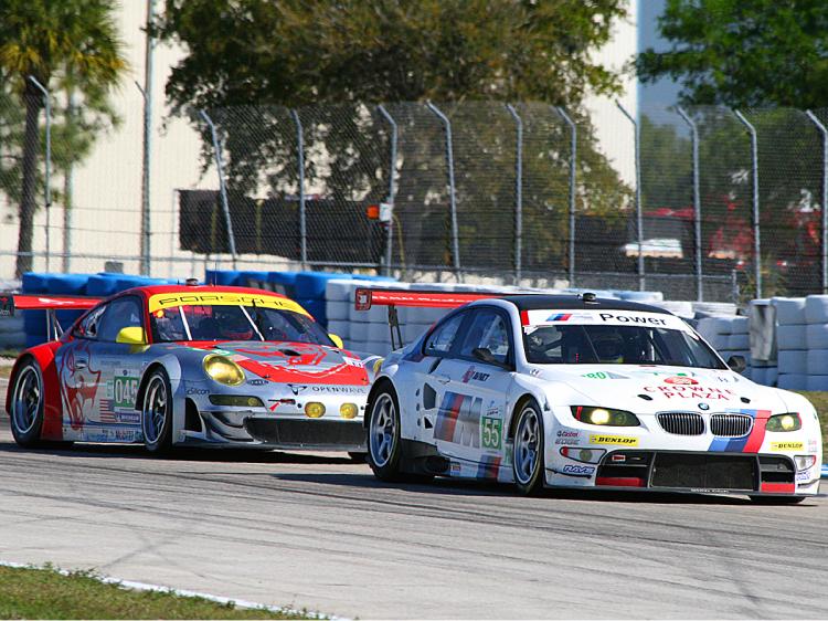 The #45 Flying Lizard Porsche chases the #55 BMW around Turn 10 at Sebring. Great GT action is a prime attraction of ALMS racing. (James Fish/The Epoch Times) The #45 Flying Lizard Porsche chases the #55 BMW around Turn 10 at Sebring. Great GT action is a prime attraction of ALMS racing. (James Fish/The Epoch Times)