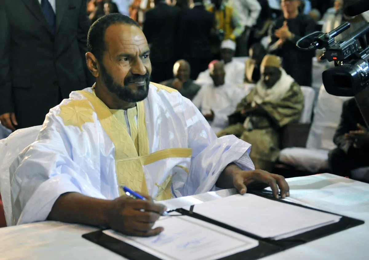 Sidi Brahim Ould Sidati, a member of the Arab Movement of Azawad, signs the ammended version of the Algerian Accord on behalf of the Coordination of Azawad Movements (CMA) in Bamako on June 20, 2015. (Habibou Kouyate/AFP/Getty Images)