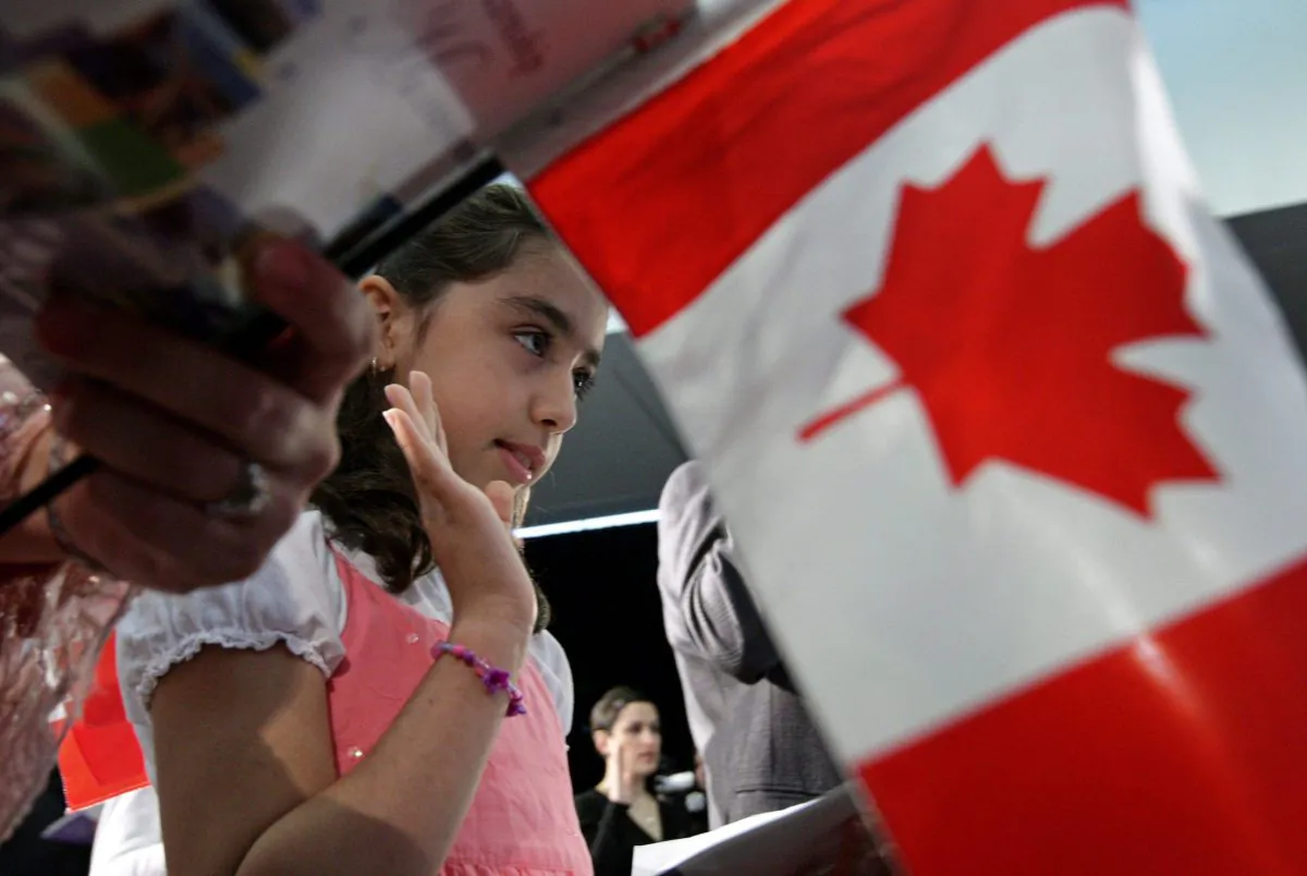 Iranian-born Negar Fakhraee, 8, takes the oath to become a Canadian citizen during a citizenship ceremony in Vancouver, B.C., on July 13, 2009. Prior research indicates that immunization rates in immigrant communities are lower than the majority of other Canadians, and a new study has found that it may be due to ineffective communication. (The Canadian Press/Darryl Dyck)