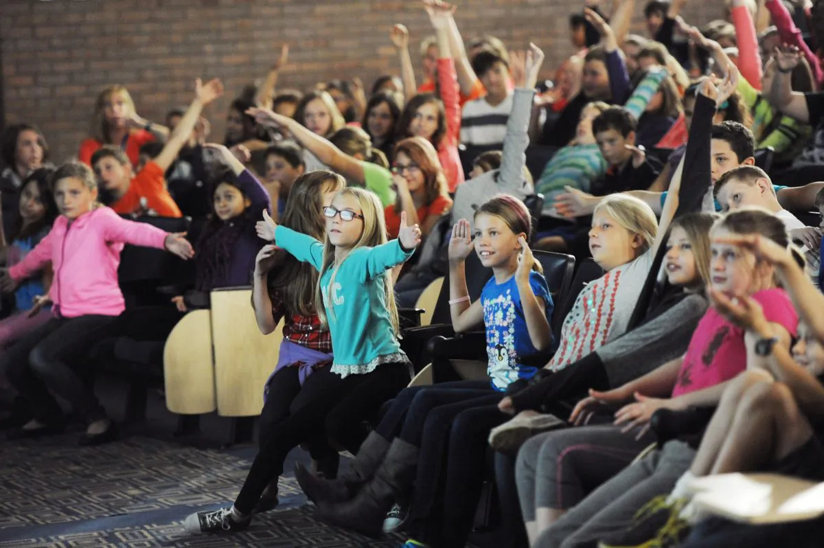 Middle school students respond to former American Idol contestant Devyn Rush as she talks about the pain bullying can cause during a bullying prevention assembly at Bridgman High School, in Bridgman, Mich., on Oct. 7, 2015. (Don Campbell/The Herald-Palladium via AP)
