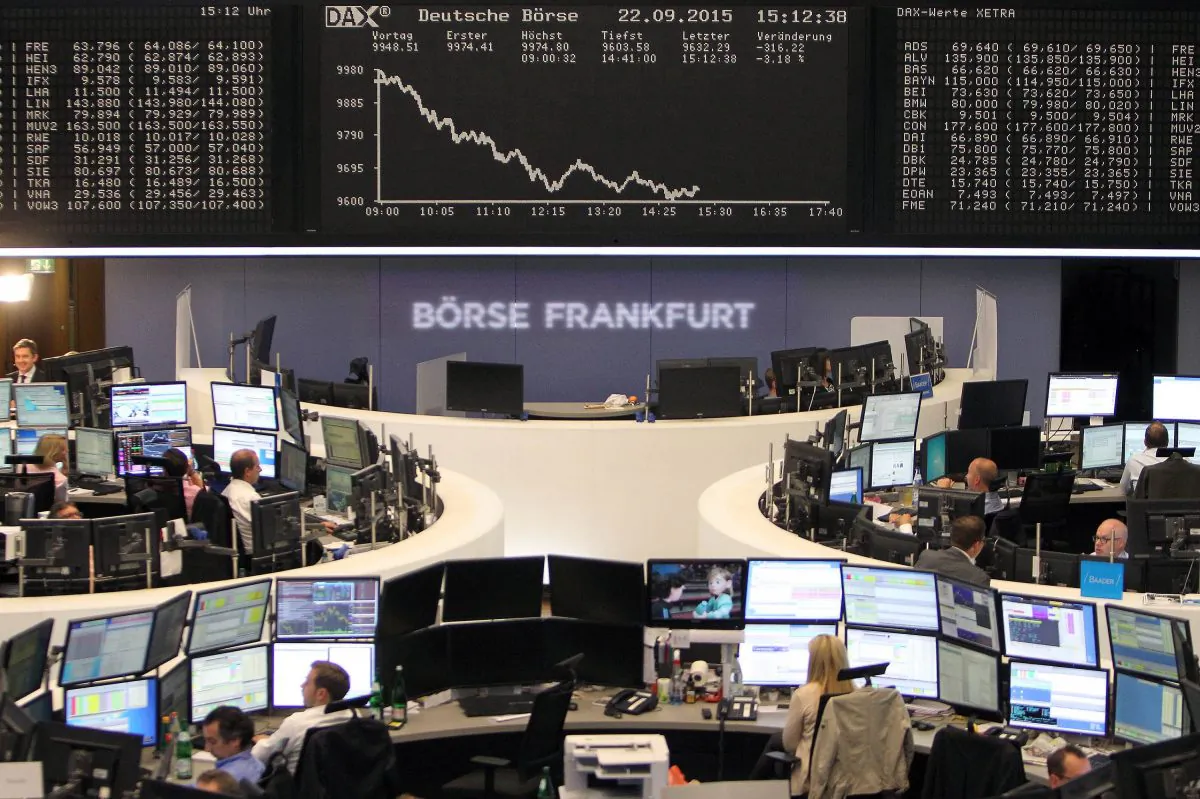 Traders work in front of a board displaying the chart of Germany's share index DAX at the stock exchange in Frankfurt am Main, western Germany, on Sept. 22, 2015. (Daniel Roland/AFP/Getty Images)